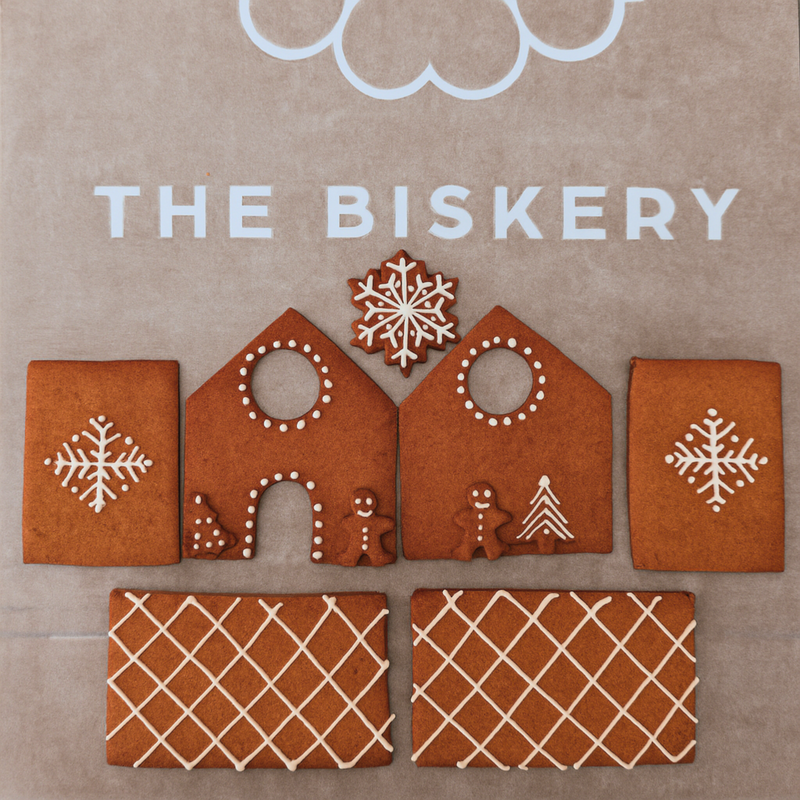DIY Biscuit Decorating Kits featuring a small gingerbread house, perfect for creative and festive fun from The Biskery Company