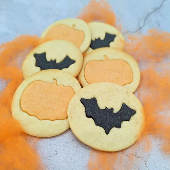 Halloween Butter Biscuit Stack with Pumpkins and Bats on the Table – The Perfect Spooky Treat from The Biskery