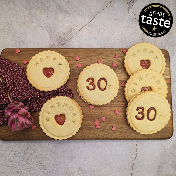 Delicious Happy 30th Birthday biscuits arranged on a cutting board