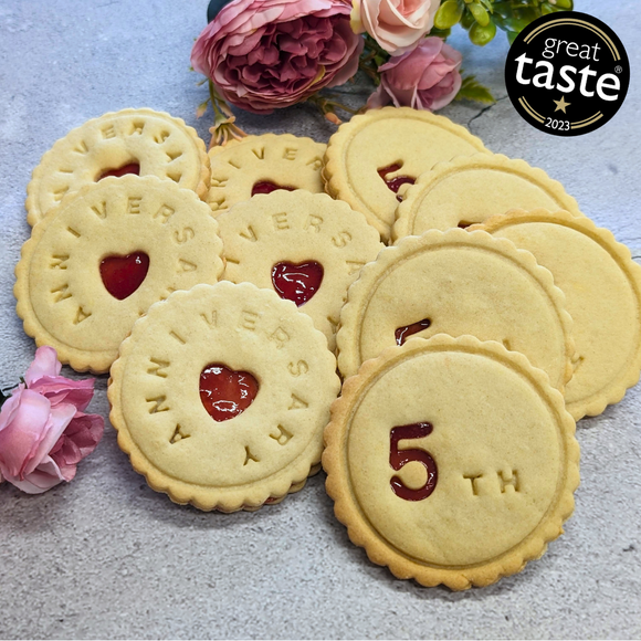 Stack of heart-shaped iced biscuits decorated for an anniversary party, perfect for sharing with loved ones. 