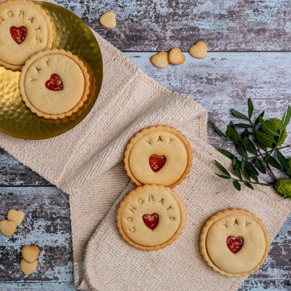 A plate of congratulations biscuits decorated with hearts and message, perfect for celebrating GCSE Results
