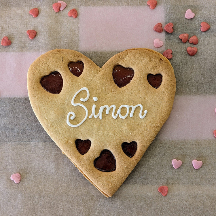 heart shaped biscuit with a name iced on it