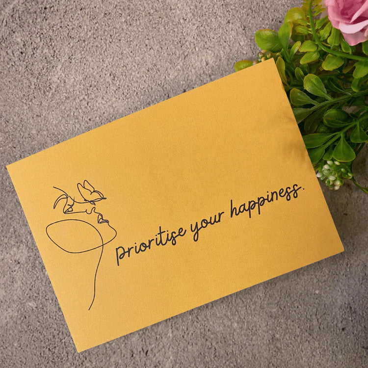 a yellow card saying prioritise your happiness