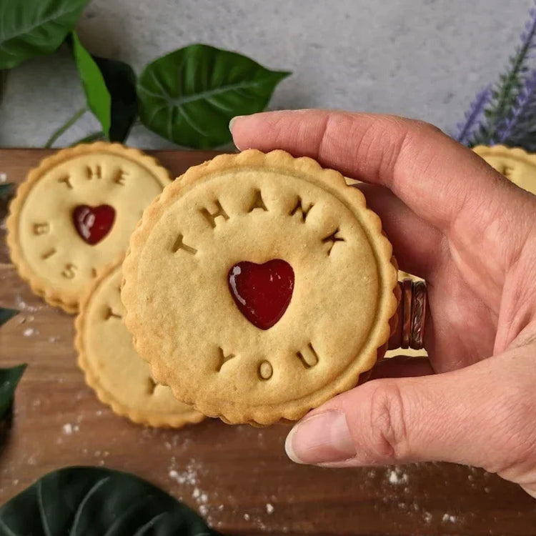 a hand held thank you biscuit
