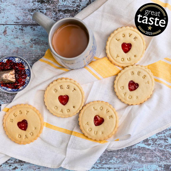 A plate of Jam Biscuits, a heart-shaped cookie, and a cup of tea, decorated with "Happy Father's Day"