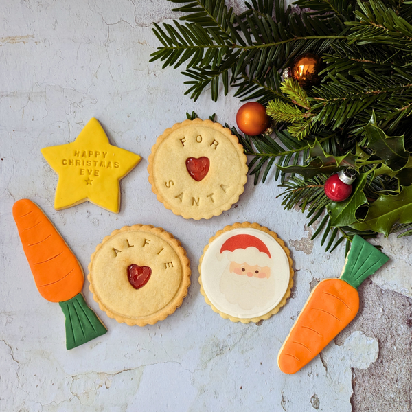 A close-up of a plate of Biscuits with a variety of shapes and decorations