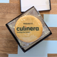 A branded cookie with the "Culinera" logo and tagline rests in a small black gift box with a welcome message.