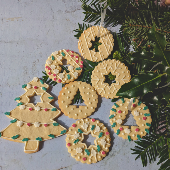 A variety of Christmas cookies in different shapes and sizes, perfect for making your own DIY Christmas tree decorations kit. Includes a Christmas tree biscuit