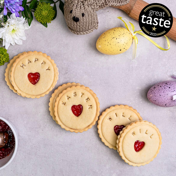 A box of Personalised Easter biscuits with the text "Happy Easter " written on them. The box is sitting on a table. 