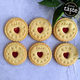 Six cookies with 'Eid Mubarak' text and red hearts on a light blue background, featuring the Great Taste 2023 award.