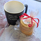 Black 'You Matter' mug with Christmas Biscuits gift pack, tied with red ribbon. Biscuit Mug Gift Set with Jam Biscuits