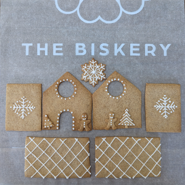 DIY Biscuit Decorating Kits featuring a small gingerbread house, perfect for creative and festive fun from The Biskery Company