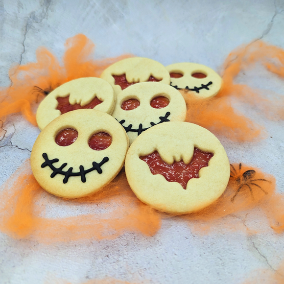  Some of the Biscuits have large, round eyes, while others have sharp teeth. There are also a few Biscuits with bats perched on top of them.