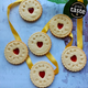 Personalised Happily Ever After Biscuits with heart-shaped jam centres, arranged with yellow ribbon on a rustic background.