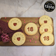 Colorful and delicious Happy 18th Birthday biscuits, arranged on a wooden cutting board.