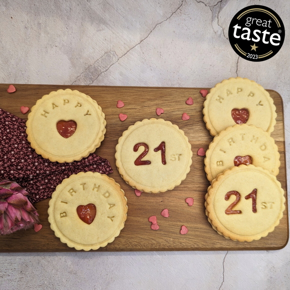 Delicious Happy 21st Birthday biscuits arranged on a wooden cutting board