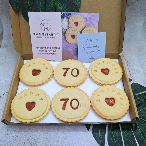 Box of delicious Happy 70th Birthday biscuits decorated with a heart-cutter 