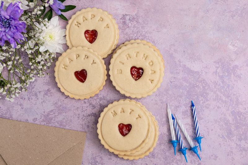 Happy Birthday Biscuits from The Biskery with candles on the table 