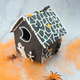 Haunted house decorating DIY kit. Gingerbread house decorated with spiders and a ghost. Perfect for a spooky Halloween display.