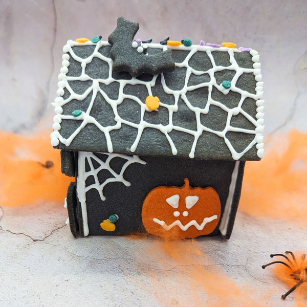 Haunted house decorating DIY kit. Black gingerbread house decorated for Halloween. Perfect for a spooky display.