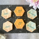 Slate tray with 4 hexagon-shaped iced biscuits celebrating a 15th anniversary/