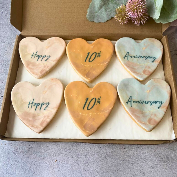 Box of six heart-shaped iced biscuits decorated with "Happy Anniversary" messages