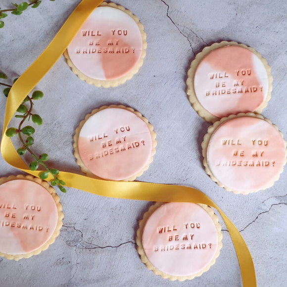 Decorated cookies with the sign "Will you be my bridesmaid?" A thoughtful gift for a friend on their wedding day.