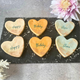 Four delicious iced birthday biscuits on a slate, perfect for a special occasion.