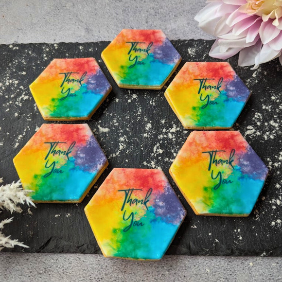 Heart-shaped iced thank you biscuits decorated with a rainbow-style 'Thank You' message