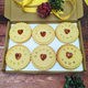 Personalised biscuit box with six jam biscuits with heart shapes and the words "I love you Grandma" written on them. Perfect for a thoughtful gift for your loved ones.
