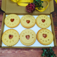 Personalised biscuit box with six jam biscuits with heart shapes and the words "I love you Grandpa" written on them. 