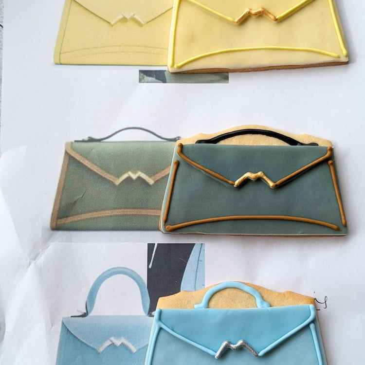Decorative hand iced handbag biscuit in various colors to compare colour to original.
