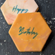 Colourful marble biscuits with 'happy' 'Birthday' written on them.