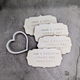 Heart-shaped biscuit cutter and stack of wedding biscuits with names, arranged on a table. Beautiful way to celebrate a wedding day.