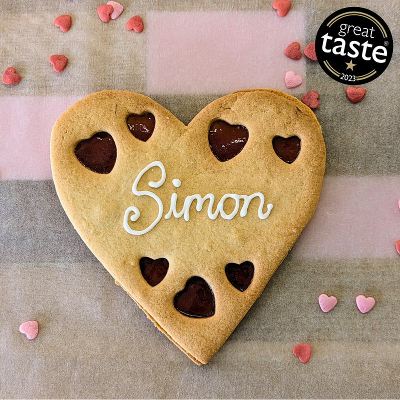 Giant Personalised Heart Cookie with the name Simon on it has. Handmade by The Biskery.