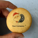 Cookie with Santa Claus illustration and 'Your Company' text held by a hand against a light background
