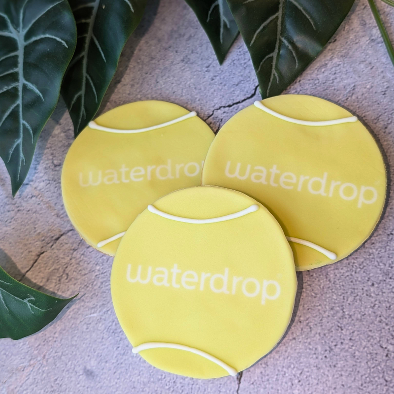 3 Tennis ball biscuits hand iced in yellow fondant. PRinted with Waterdrop branding