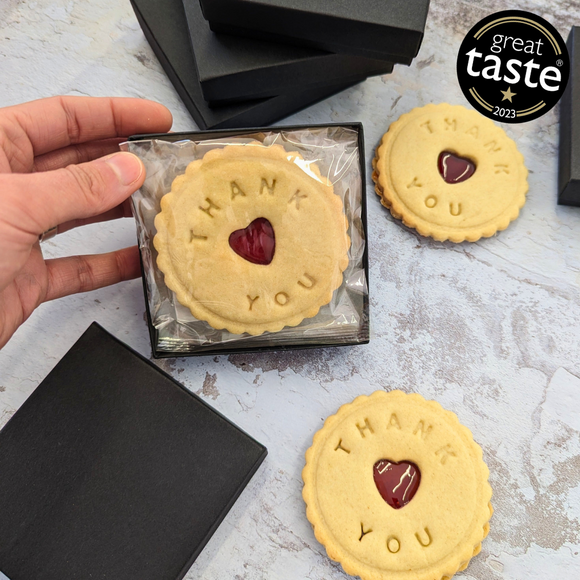 Box of heart-shaped biscuit with "Thank You" written on them. The Biskery, personalised biscuit company. Free shipping to the UK