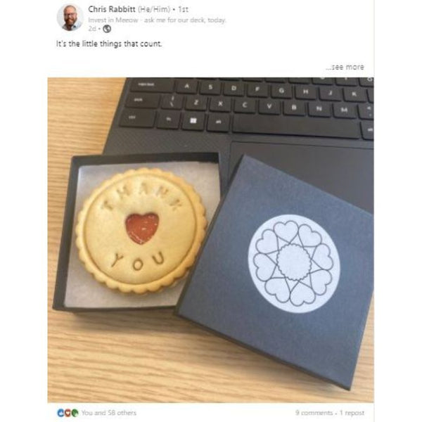 Thank You Biscuit in box on desk next to laptop