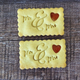 Two rectangular Wedding Jam Biscuits embossed with "Mr & Mrs" and a heart-shaped jam centre.