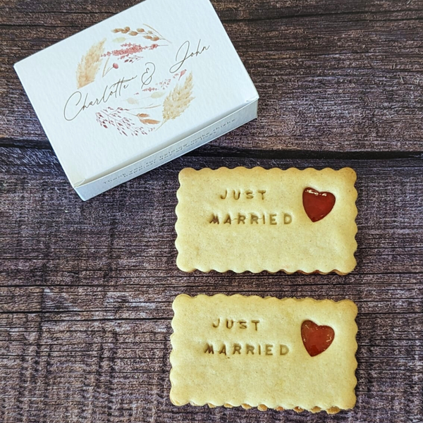Personalised Wedding Favours: Two rectangular biscuits with "Just Married" embossed and a heart-shaped jam centre, presented in a gift box with the names "Charlotte & John".