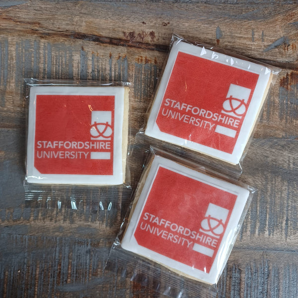 A group of three biscuits with the Staffordshire University logo on them