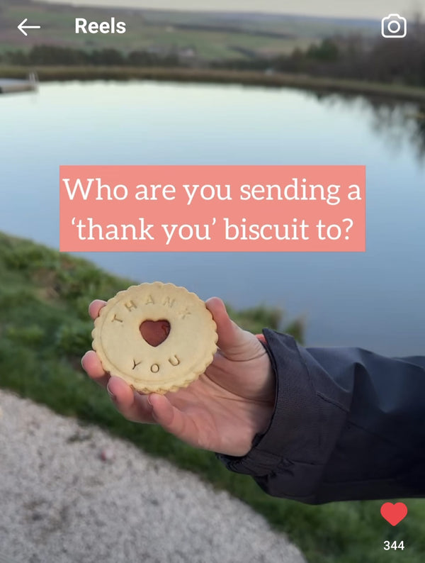 Thank You biscuits in someone's hand outside in the countryside