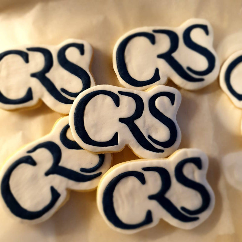 Cookies with 'CRS' icing on a light background
