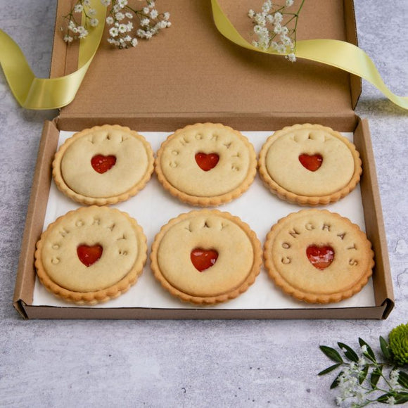 A box of congratulations biscuits decorated with hearts and message, perfect for celebrating special occasions