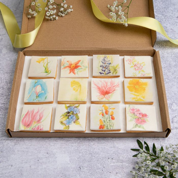 A box of of Garden Flower Biscuits from The Biskery, a variety of flower topped square biscuits made with all-natural ingredients.