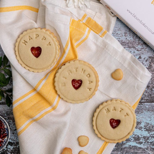 Birthday jam biscuits on a tea towel