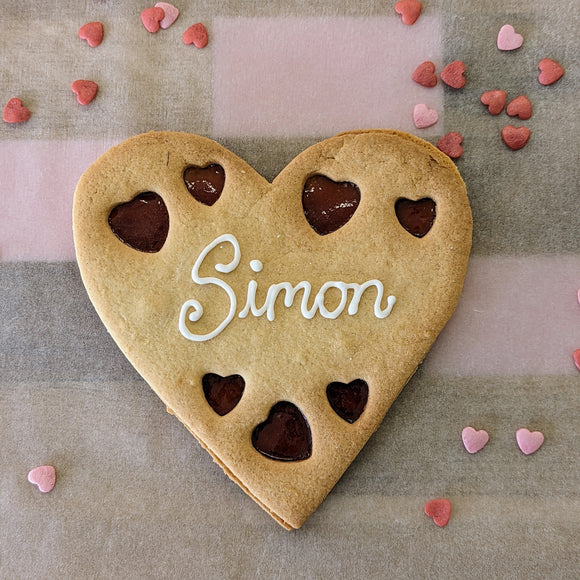 Giant Valentine's Heart Biscuit with the name Simon on it has."