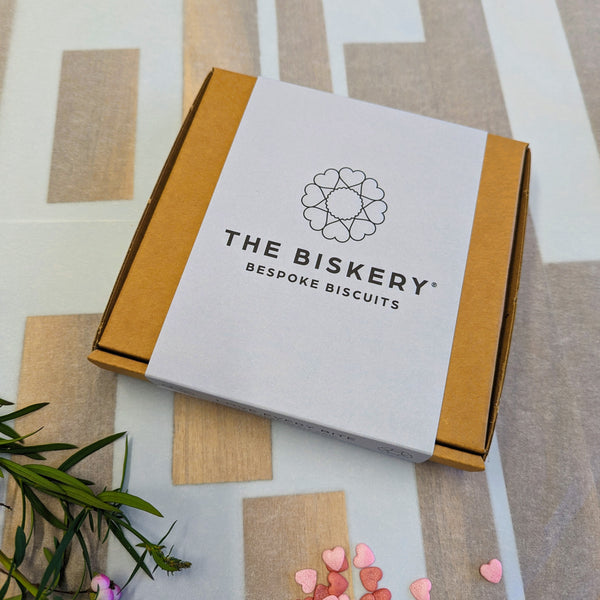 a box labelled "The Biskery" and "Bespoke Biscuits" Inside the box are valentine's biscuits.