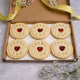 Box of heart-shaped biscuits with "Thank You" written on them. The Biskery, personalised biscuit company. Free shipping to the UK